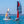 Load image into Gallery viewer, Red MiniCat 460 Esprit and a Orange Minicat 430 Evoque sailing by a bridge