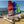 Load image into Gallery viewer, Red and Blue MiniCat 310 Sports beside a MiniCat Guppy on the beach
